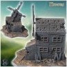 Old wooden windmill with broken blades, damaged walls, and scattered debris on a rocky base (25)