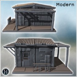 Small corrugated metal hut with damaged roof and wooden supports on a simple platform (12)