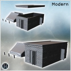 Petit bâtiment en briques avec toit plat et deux portes, adjacent à une tente (2)